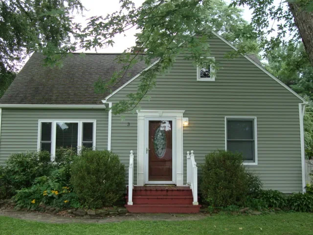 Updated home entrance and gray siding