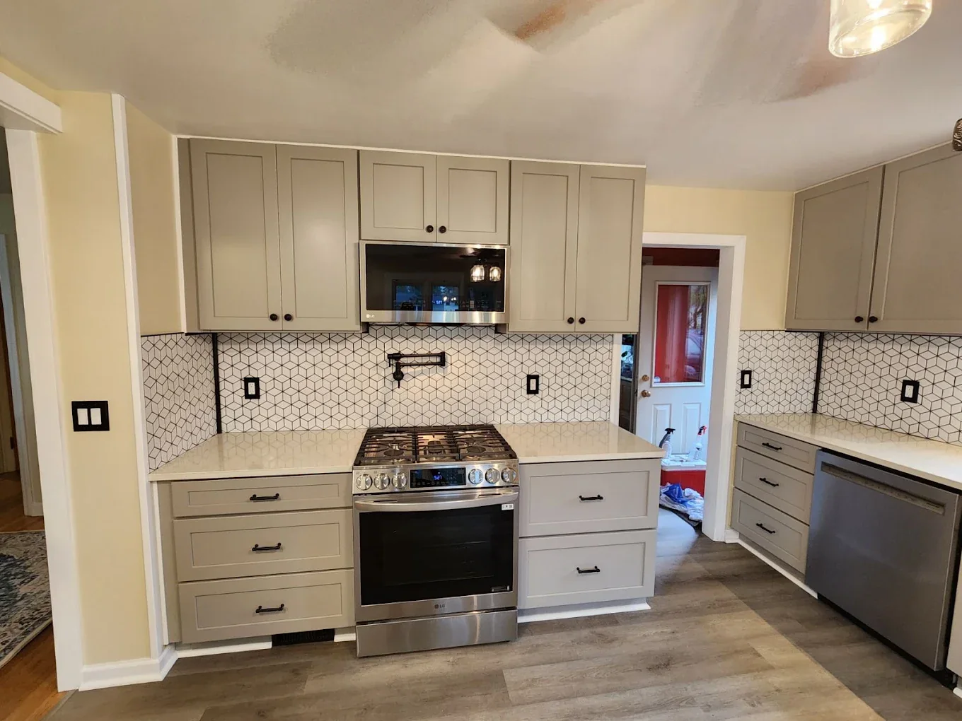 Renovated compact kitchen with white cabinets