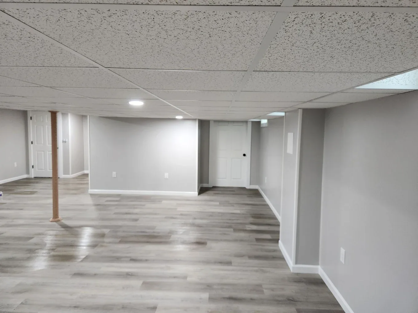 Spacious finished basement with gray plank flooring