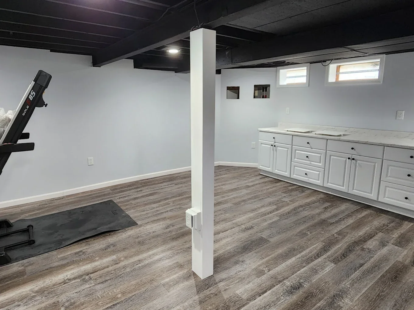 Finished basement with white kitchenette