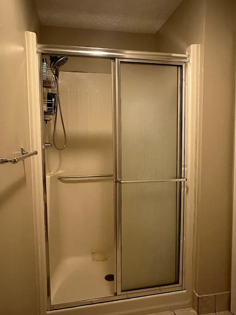 Bathroom with updated sliding glass tub and shower enclosure