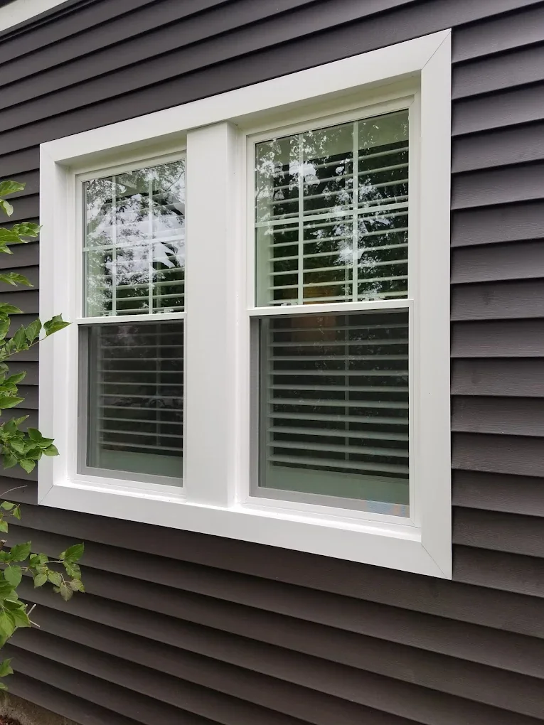 New windows installed in dark house siding